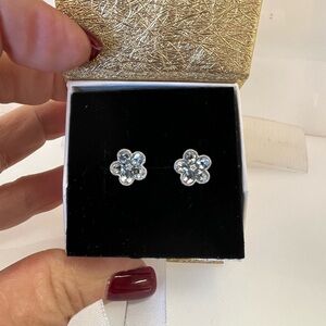 14 karat white gold and flower 🌸 shaped earrings with 1.78 blue topaz stones.